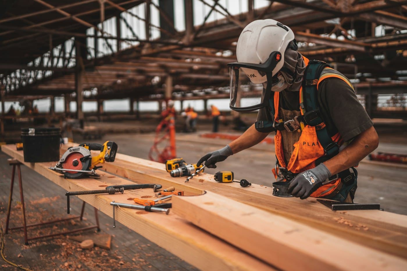 Carpenter measuring lumber on a job site