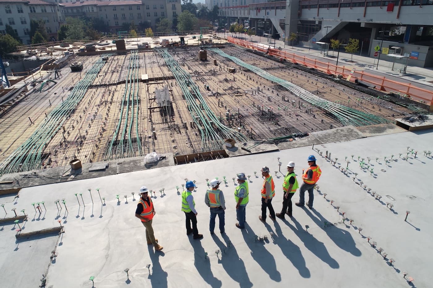 Crew in safety vests reviewing a large foundation site