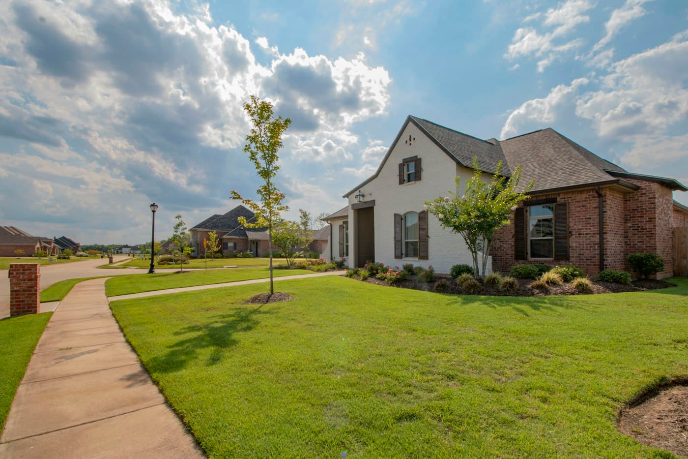 Home with a freshly landscaped lawn and young trees